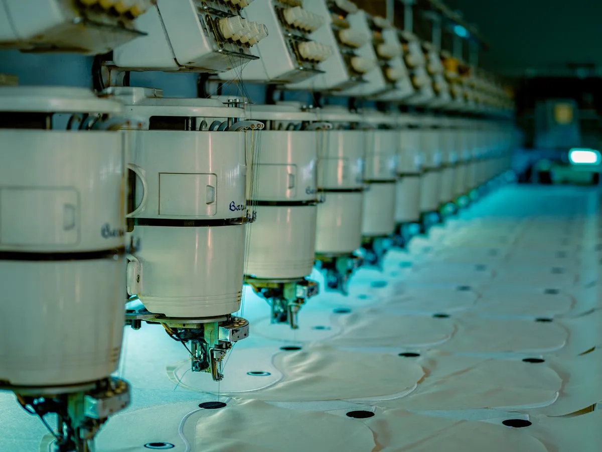 Clean embroidery workshop in Ajman with machines and folded uniforms